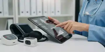 Healthcare professional reviewing remote patient monitoring data on a tablet